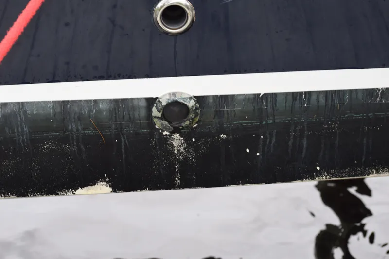 Slide: The Image of 2022 Pursuit OS 355 Offshore boat hull with visible waterline and fittings. - 449