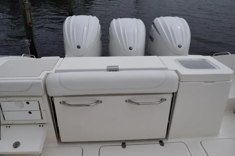 Slide: The Image of 2022 Pursuit OS 355 Offshore boat with triple outboard engines and sleek white deck design. - 52