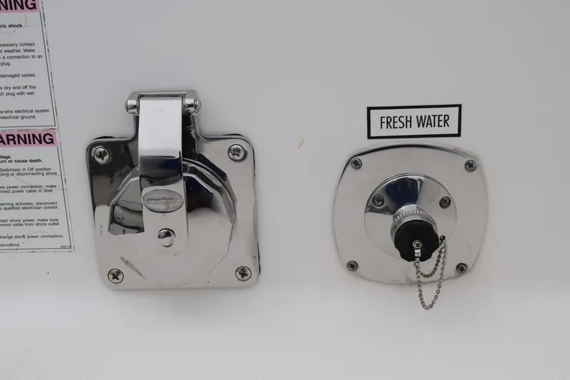 Slide: The Image of 2022 Pursuit OS 355 Offshore boat, fresh water inlet and electrical outlet. - 95