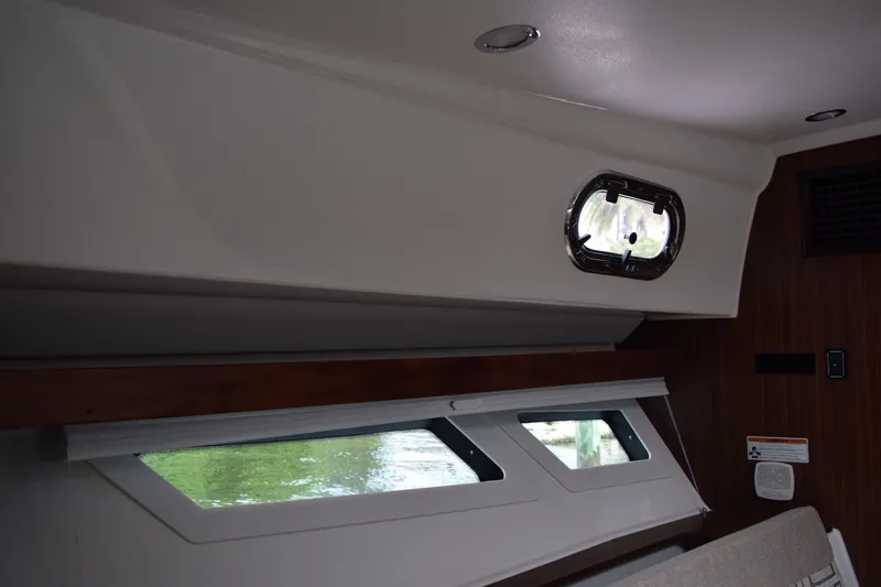 Slide: The Image of Interior view of 2022 Pursuit OS 355 Offshore boat cabin with windows and modern design. - 400
