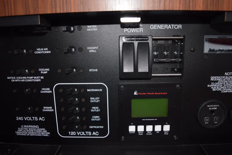 Slide: The Image of Control panel of a 2022 Pursuit OS 355 Offshore boat with generator and power switches. - 412