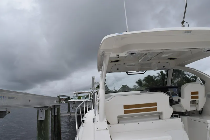 Slide: The Image of 2022 Pursuit OS 355 Offshore boat docked under cloudy skies. - 81
