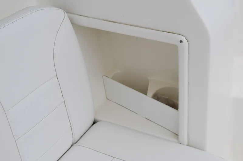Slide: The Image of 2022 Pursuit OS 355 Offshore boat interior with white seating and storage compartment. - 32
