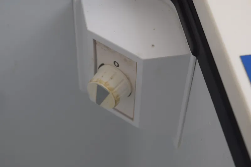 Slide: The Image of Close-up of a control knob on a 2022 Pursuit OS 355 Offshore boat. - 182