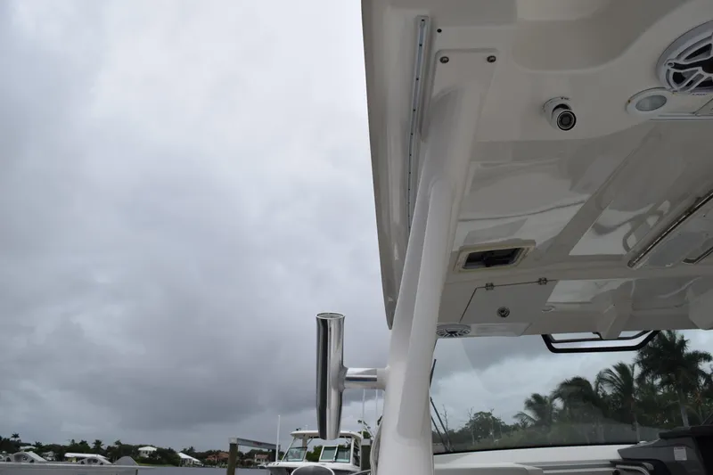 Slide: The Image of 2022 Pursuit OS 355 Offshore boat under cloudy sky, showcasing sleek design and structure. - 153