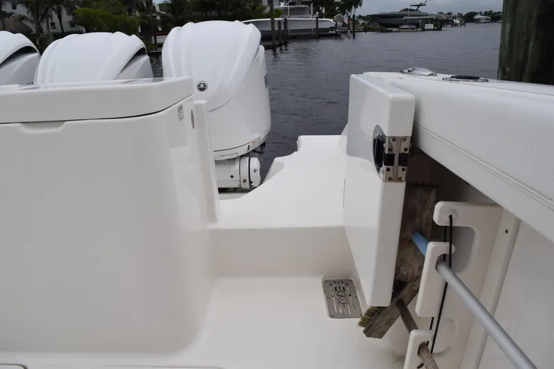 Slide: The Image of 2022 Pursuit OS 355 Offshore boat with outboard motors docked by the water. - 106