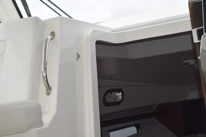 Slide: The Image of 2022 Pursuit OS 355 Offshore cabin entrance with sleek interior and stainless steel handle. - 327