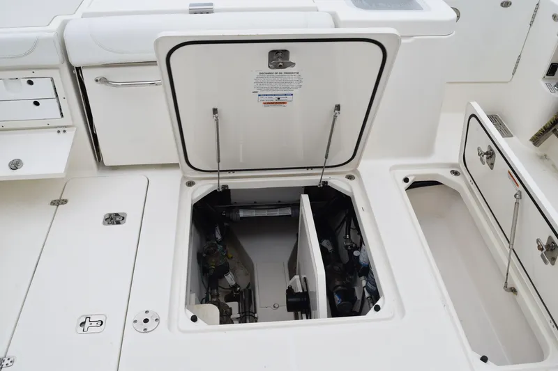 Slide: The Image of 2022 Pursuit OS 355 Offshore boat storage compartments and access hatches open. - 126