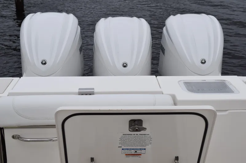 Slide: The Image of Triple outboard engines on a 2022 Pursuit OS 355 Offshore boat. - 147