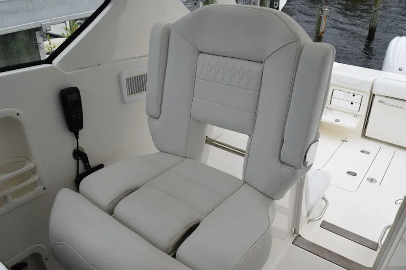 Slide: The Image of 2022 Pursuit OS 355 Offshore boat interior with luxurious white captain's chair. - 253