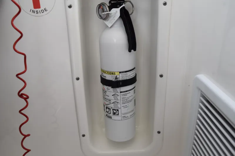 Slide: The Image of Fire extinguisher mounted on 2022 Pursuit OS 355 Offshore boat interior. - 269