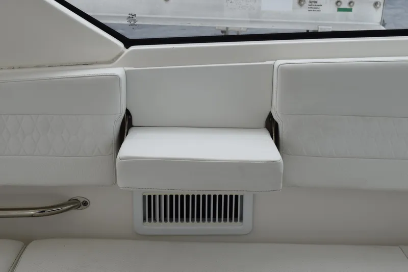 Slide: The Image of 2022 Pursuit OS 355 Offshore interior with white cushioned seating and ventilation grille. - 245