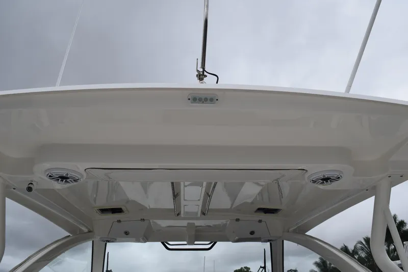 Slide: The Image of 2022 Pursuit OS 355 Offshore boat roof with speakers and lighting fixtures. - 18
