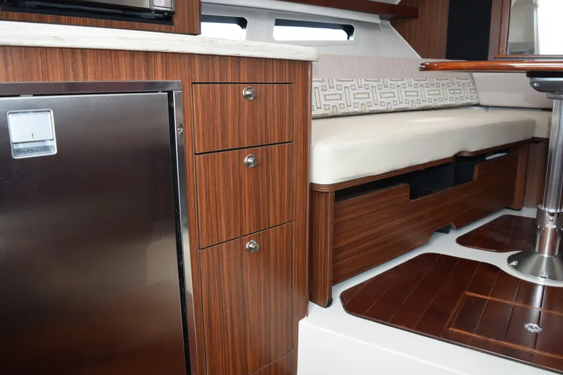 Slide: The Image of Luxurious interior of 2022 Pursuit OS 355 Offshore boat with wood cabinetry and seating. - 417