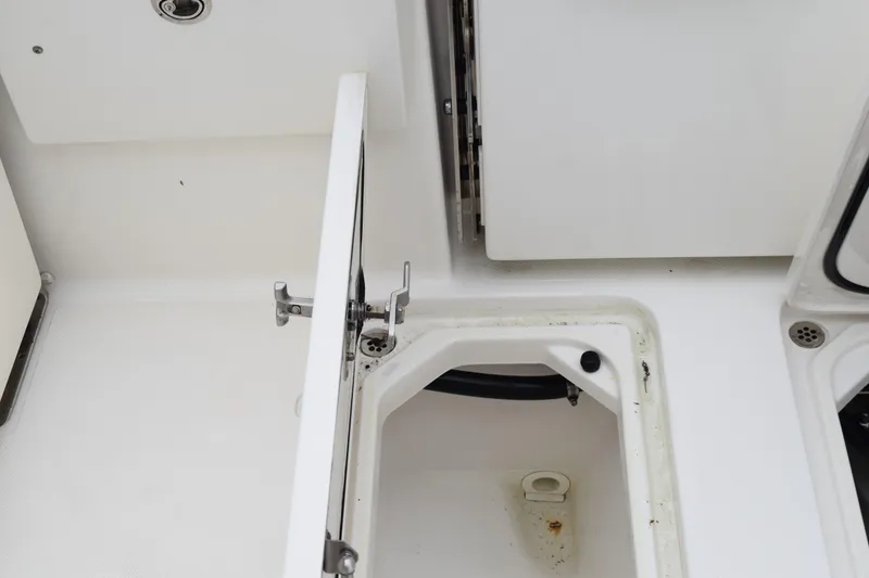 Slide: The Image of 2022 Pursuit OS 355 Offshore boat storage compartment with open hatch. - 142