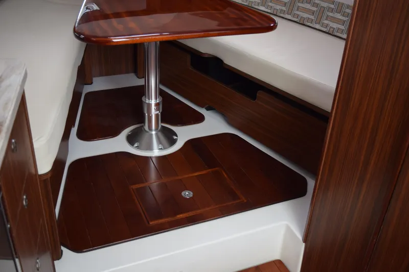 Slide: The Image of 2022 Pursuit OS 355 Offshore cabin interior with wooden flooring and seating area. - 435