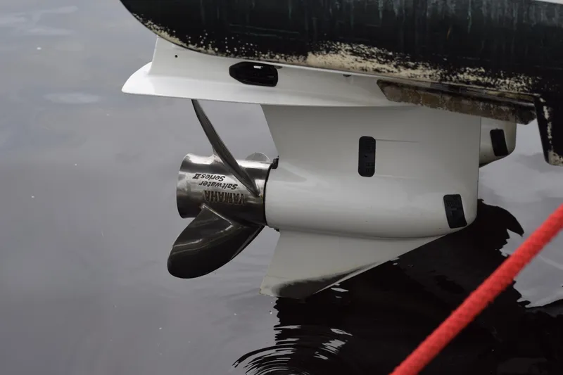 Slide: The Image of Propeller of 2022 Pursuit OS 355 Offshore boat in water, close-up view. - 452