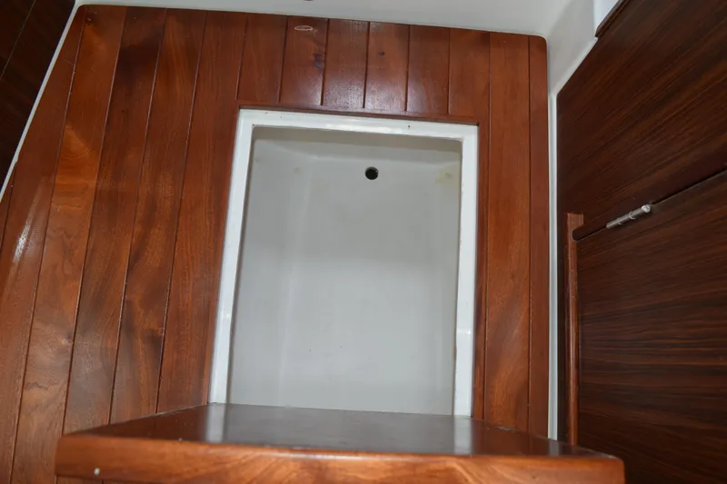 Slide: The Image of Interior of 2022 Pursuit OS 355 Offshore boat with wooden paneling. - 444