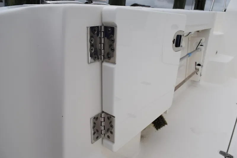 Slide: The Image of 2022 Pursuit OS 355 Offshore boat hinge detail, showcasing stainless steel hardware. - 76