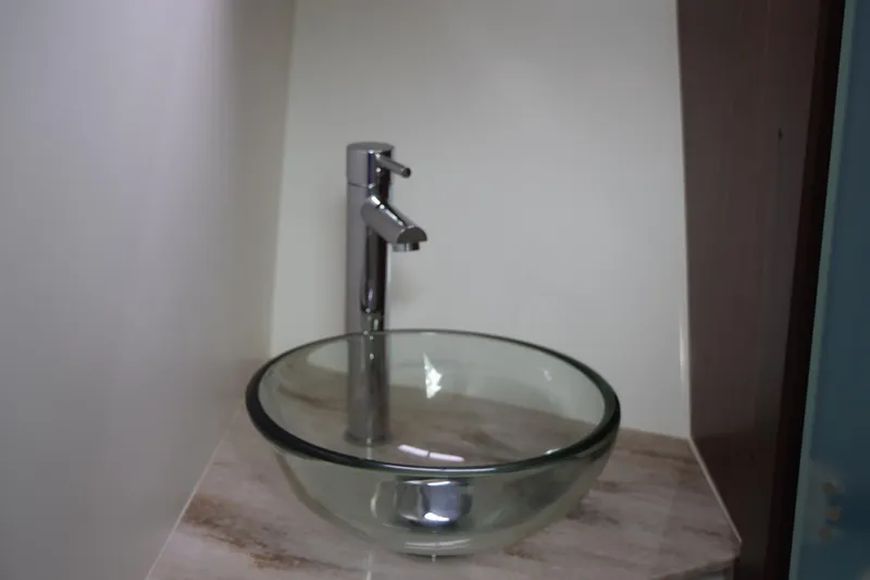 Slide: The Image of Glass vessel sink with modern faucet in 2022 Pursuit OS 355 Offshore boat. - 379
