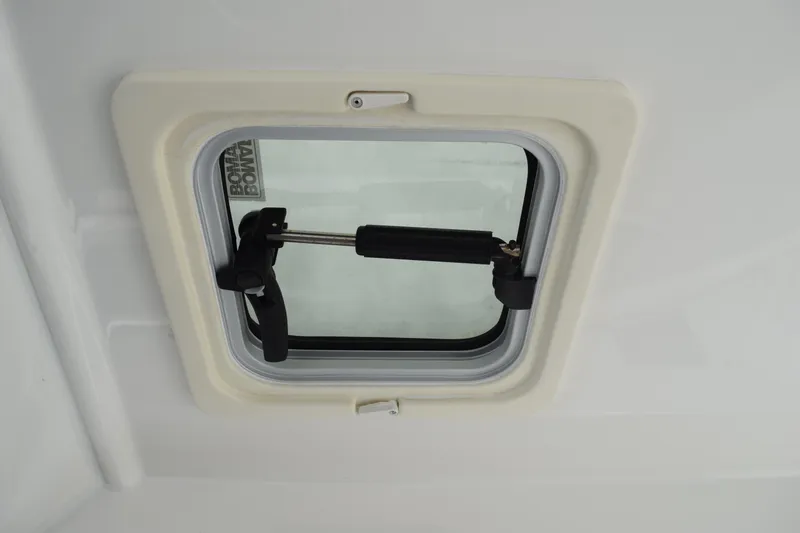 Slide: The Image of 2022 Pursuit OS 355 Offshore boat window with secure latch mechanism. - 224
