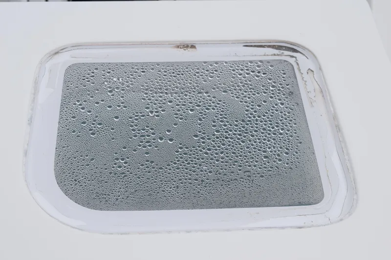 Slide: The Image of Close-up of a 2022 Pursuit OS 355 Offshore window with condensation droplets. - 54