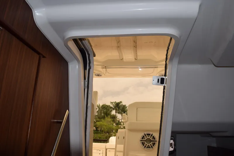 Slide: The Image of Interior view of 2022 Pursuit OS 355 Offshore boat, showcasing door and seating area. - 353