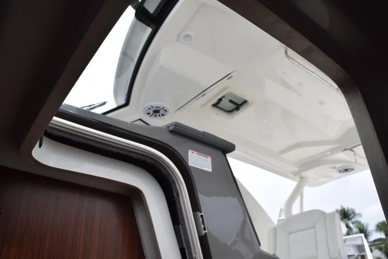 Slide: The Image of 2022 Pursuit OS 355 Offshore boat interior view with open hatch and seating. - 342