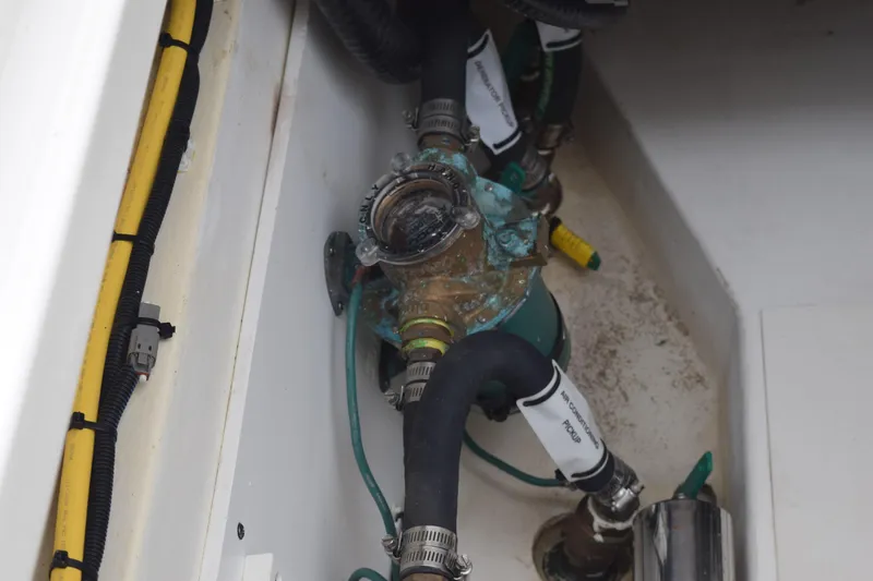 Slide: The Image of 2022 Pursuit OS 355 Offshore boat engine compartment with hoses and wiring. - 129