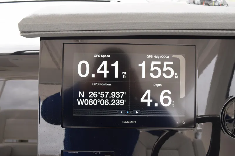 Slide: The Image of Dashboard of 2022 Pursuit OS 355 Offshore showing GPS speed, heading, and depth. - 275