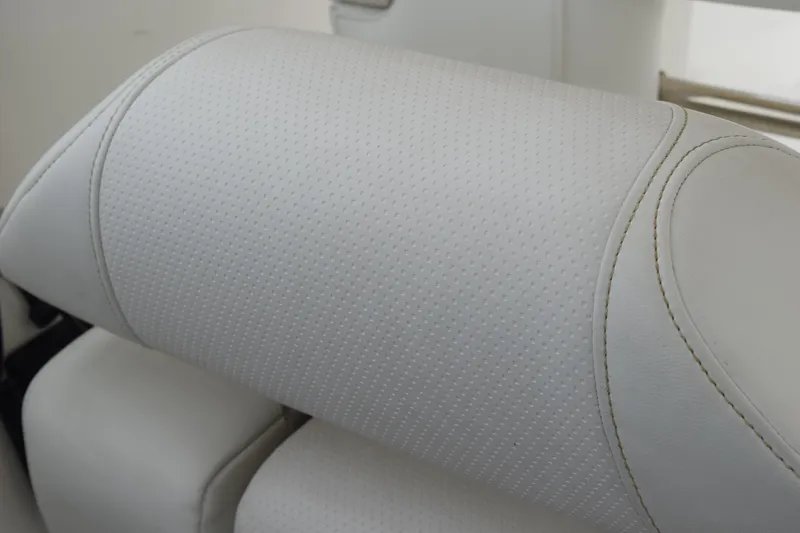 Slide: The Image of White leather seat detail on 2022 Pursuit OS 355 Offshore boat. - 256