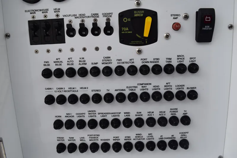 Slide: The Image of Control panel of a 2022 Pursuit OS 355 Offshore boat with various switches and indicators. - 170