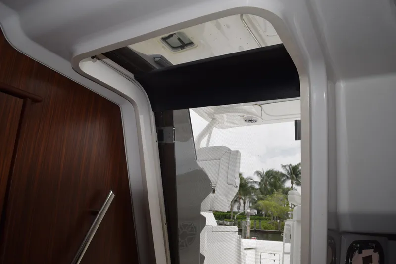 Slide: The Image of Interior view of 2022 Pursuit OS 355 Offshore boat, showcasing cabin entrance and seating area. - 350