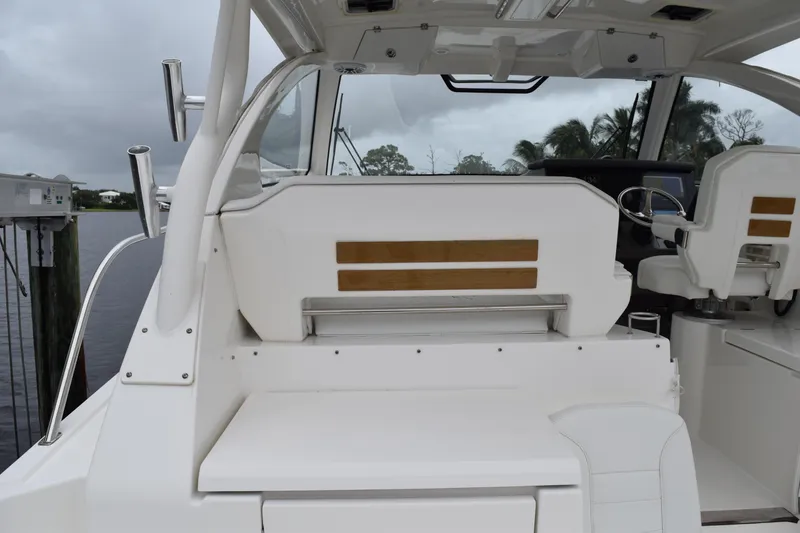 Slide: The Image of 2022 Pursuit OS 355 Offshore boat interior with seating and steering wheel. - 151