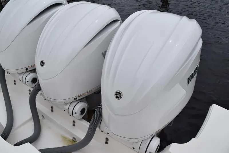 Slide: The Image of Triple Yamaha outboard engines on a 2022 Pursuit OS 355 Offshore boat. - 91
