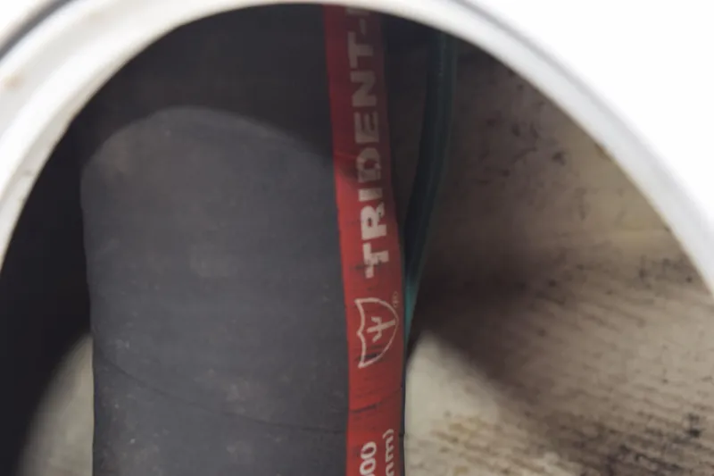 Slide: The Image of Close-up of a Trident marine hose inside a 2022 Pursuit OS 355 Offshore boat. - 85