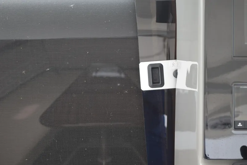 Slide: The Image of 2022 Pursuit OS 355 Offshore boat detail with screen and latch mechanism. - 320