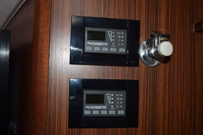 Slide: The Image of Dometic control panels on 2022 Pursuit OS 355 Offshore boat interior. - 374