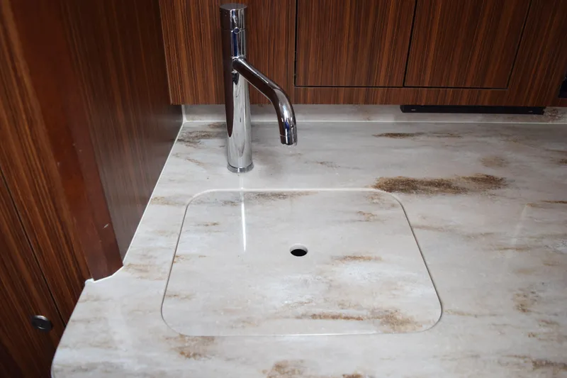 Slide: The Image of Luxury kitchen sink in 2022 Pursuit OS 355 Offshore boat, featuring sleek faucet design. - 430