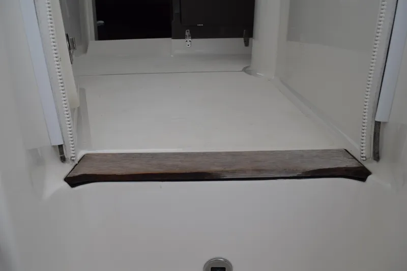 Slide: The Image of 2022 Pursuit OS 355 Offshore boat interior with wooden step detail. - 162