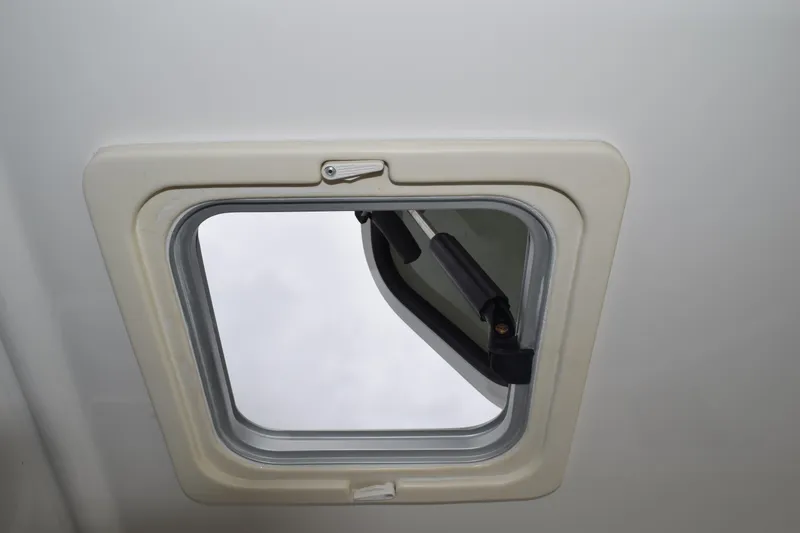 Slide: The Image of Hatch window of 2022 Pursuit OS 355 Offshore boat, partially open. - 223