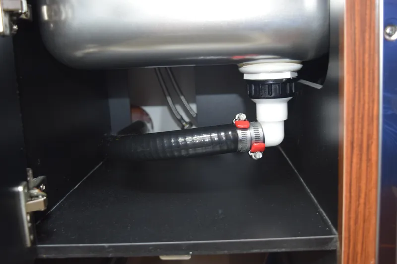 Slide: The Image of Under-sink plumbing in 2022 Pursuit OS 355 Offshore boat, featuring hose and fittings. - 429