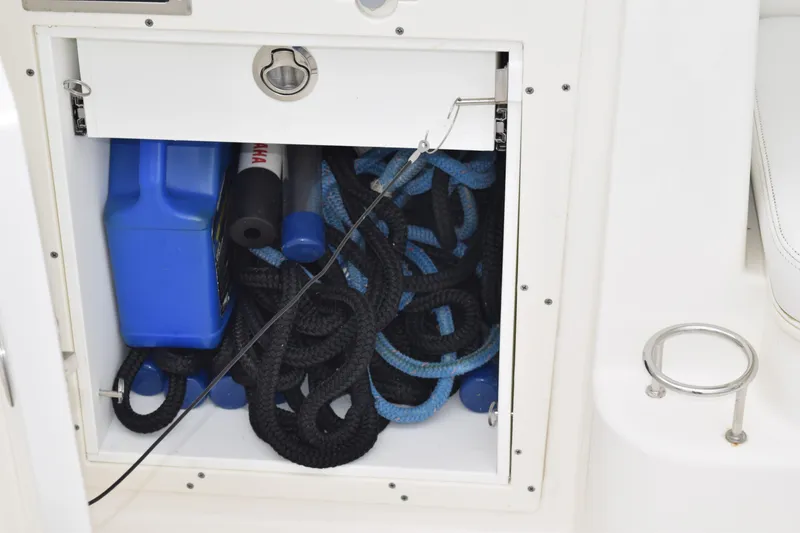 Slide: The Image of Storage compartment on 2022 Pursuit OS 355 Offshore boat with ropes and equipment. - 37