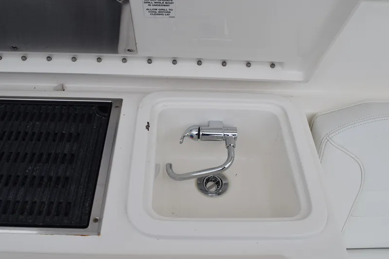 Slide: The Image of 2022 Pursuit OS 355 Offshore boat sink and grill area. - 194