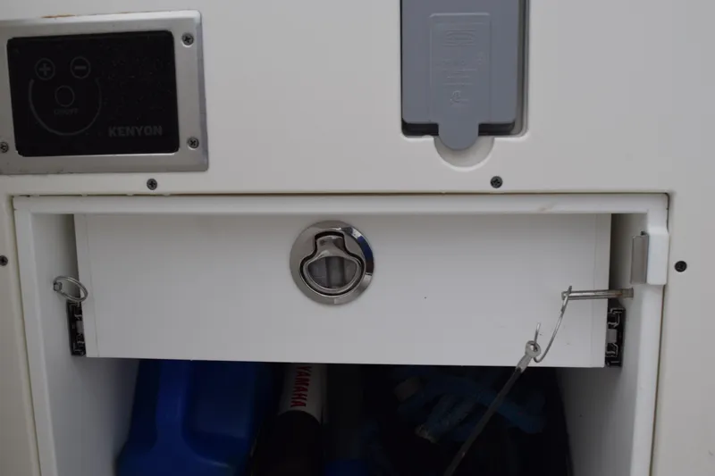 Slide: The Image of 2022 Pursuit OS 355 Offshore storage compartment with Kenyon control panel. - 42