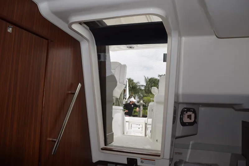 Slide: The Image of Interior view of 2022 Pursuit OS 355 Offshore boat, showing cabin entrance and deck. - 360