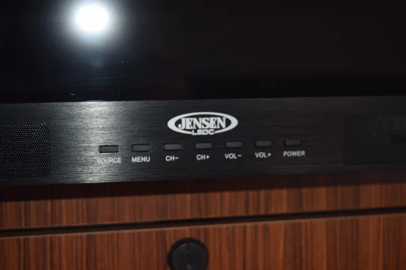 Slide: The Image of Jensen LED TV control panel on 2022 Pursuit OS 355 Offshore boat. - 406