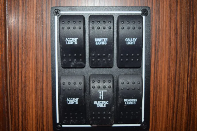 Slide: The Image of Switch panel on 2022 Pursuit OS 355 Offshore boat, featuring various light controls. - 371