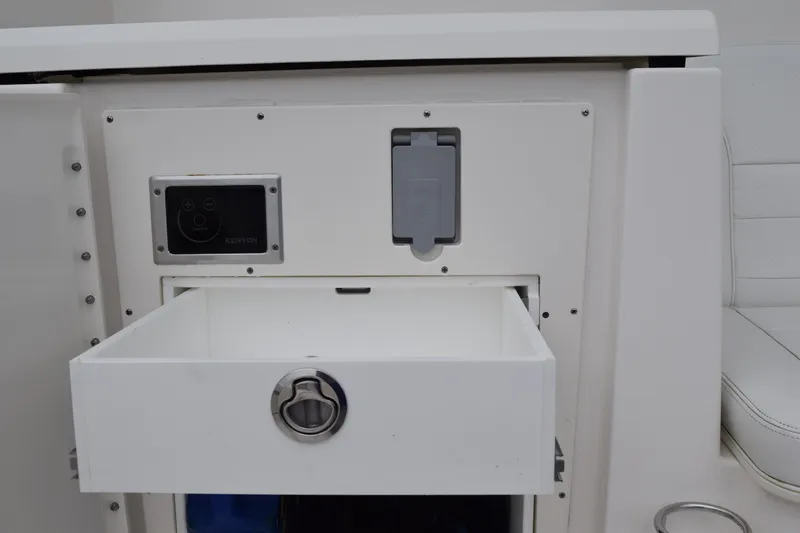 Slide: The Image of 2022 Pursuit OS 355 Offshore boat interior drawer with control panel. - 43