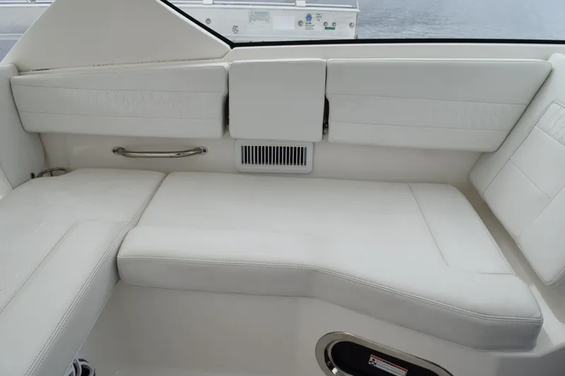 Slide: The Image of 2022 Pursuit OS 355 Offshore boat interior with white cushioned seating. - 238